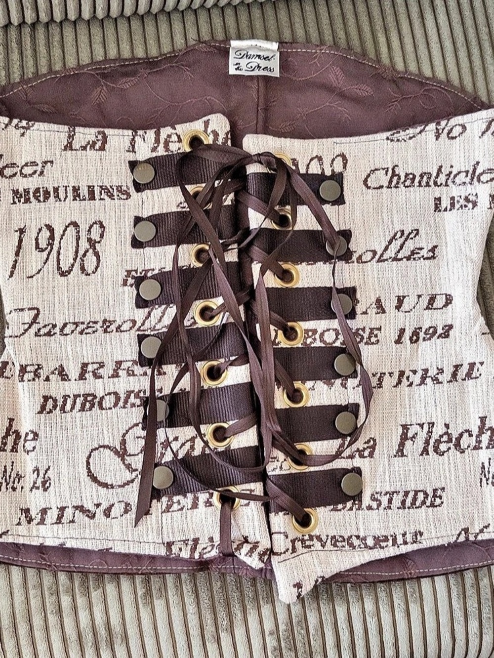 Damsel in this Dress Corset Brown & Cream Lace-Up with cursive writing